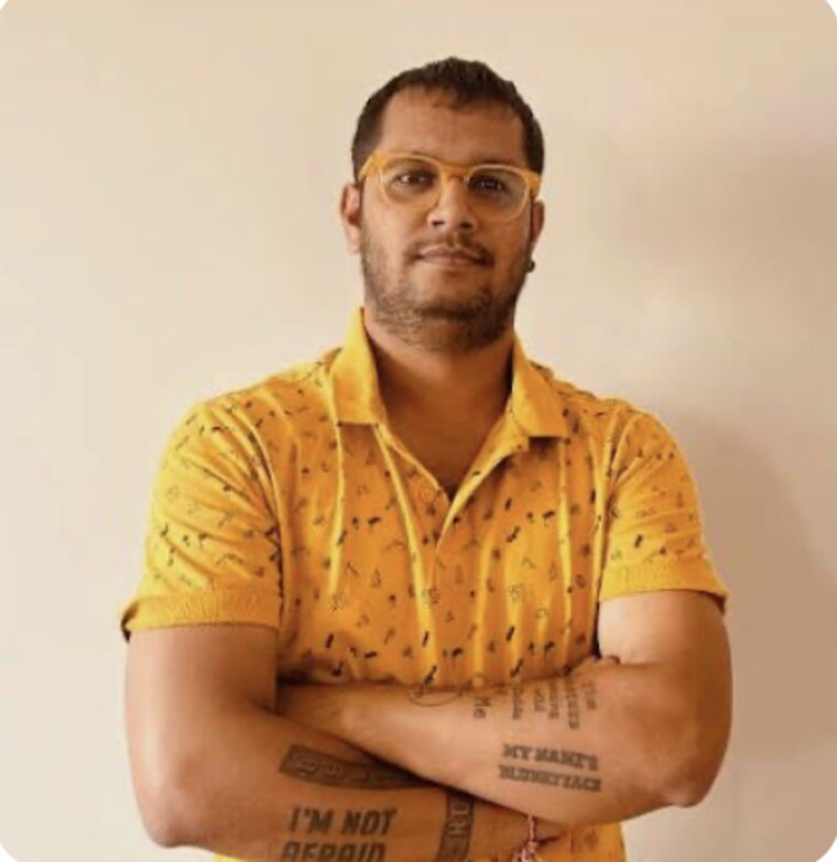 Bhavik Sarkhedi in a mustard shirt with tattoos